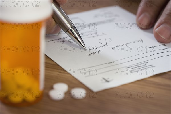 Close up of man filling out prescription