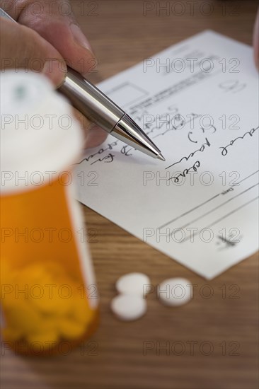 Close up of man filling out prescription