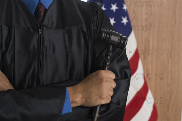 Close of African male judge holding gavel