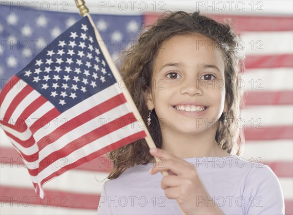 Young girl holding American flag