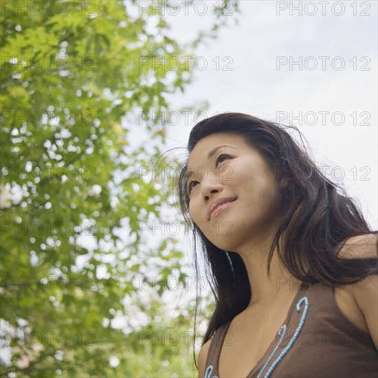 Low angle view of young Asian woman outdoors