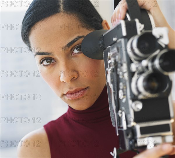 African woman using old fashioned film camera