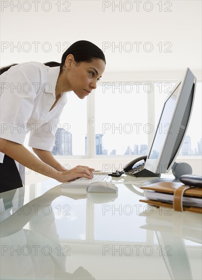 African businesswoman looking at computer