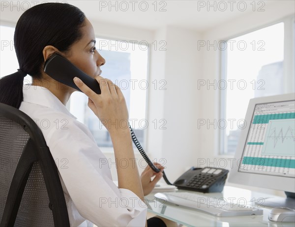African businesswoman talking on telephone