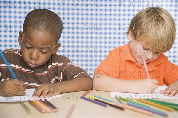 Two young boys coloring