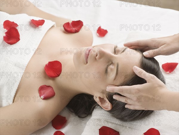 Hispanic woman receiving massage