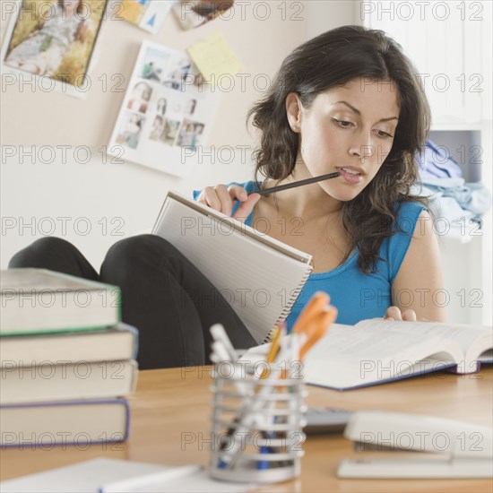 Portrait of Hispanic woman studying
