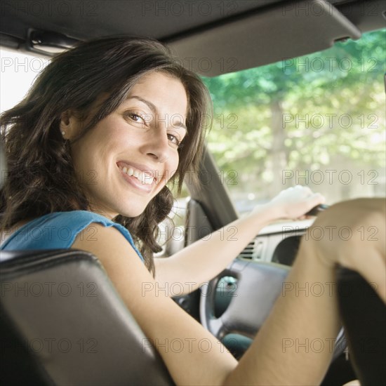 Hispanic woman in driver's seat of car