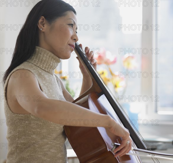 Asian woman playing cello