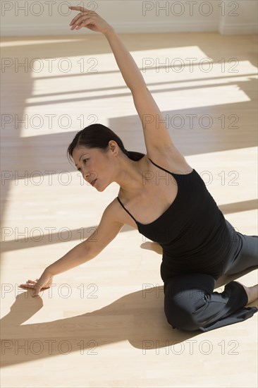 Middle-aged Asian female dancer practicing