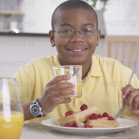 African boy eating breakfast