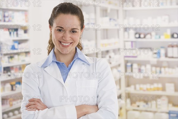 Hispanic female pharmacist smiling in pharmacy