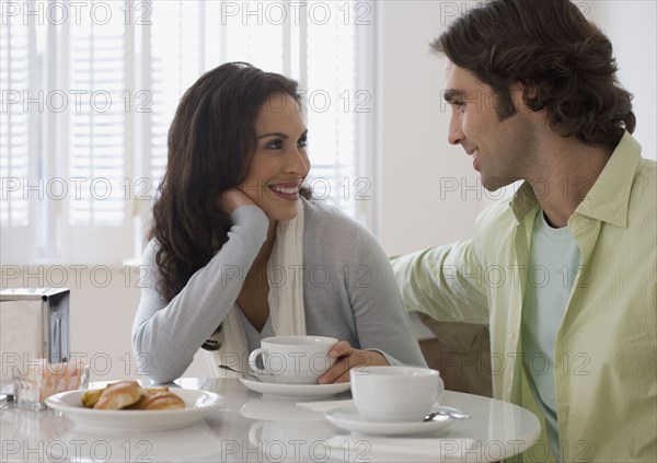 Hispanic couple at breakfast table