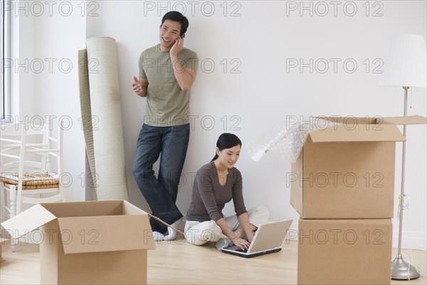 Asian couple taking break from moving