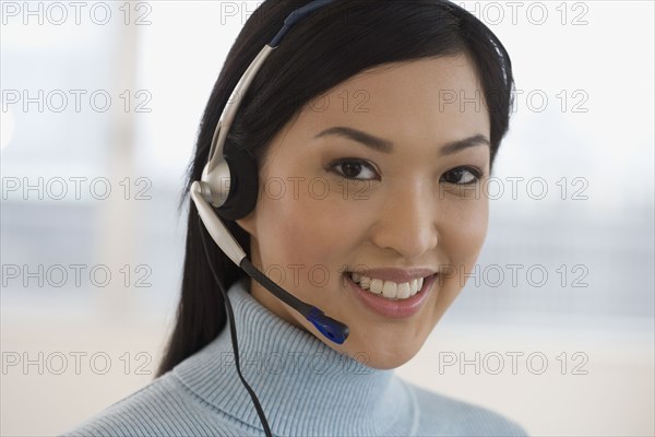 Asian businesswoman wearing headset