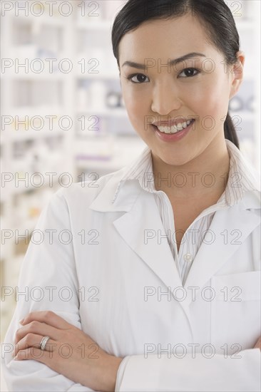 Asian female pharmacist standing in pharmacy