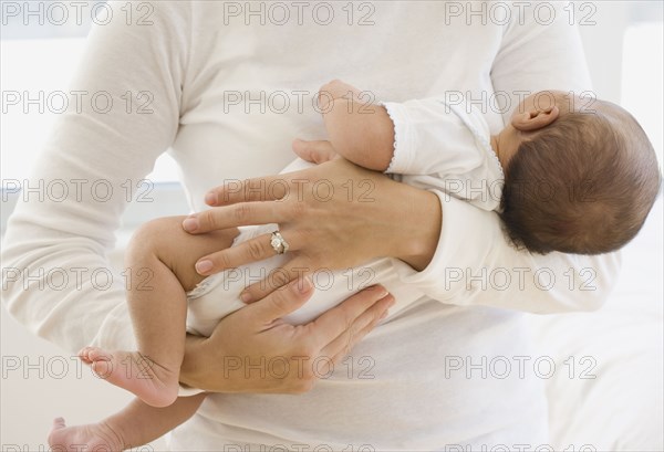 Close up of mother holding newborn baby