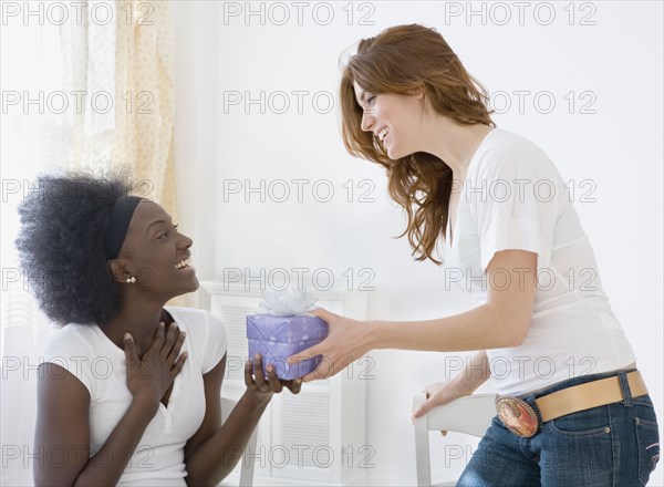 Two women exchanging gifts