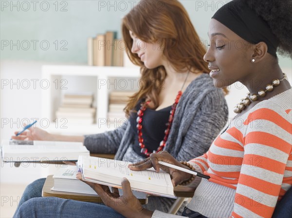 Two female college students studying in class