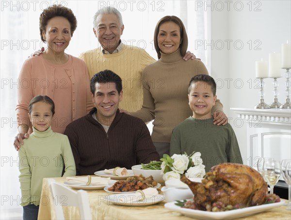 Multi-generational Hispanic family at Thanksgiving table