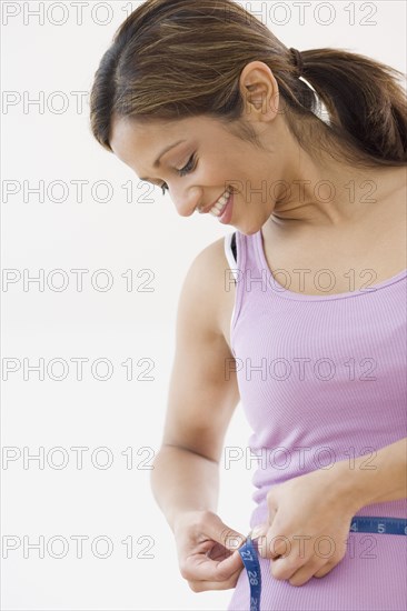 Indian woman measuring waist