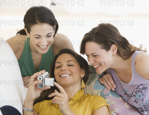 Three young women looking at video camera