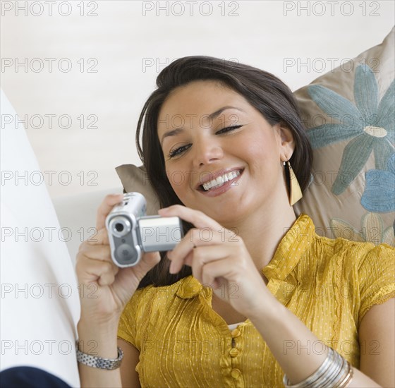 Hispanic woman looking at video camera