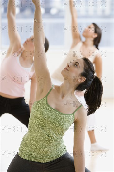 Three young women in yoga class