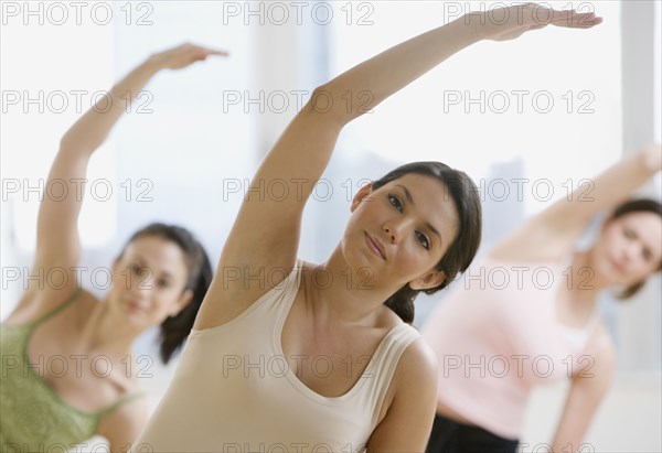 Three young women in yoga class