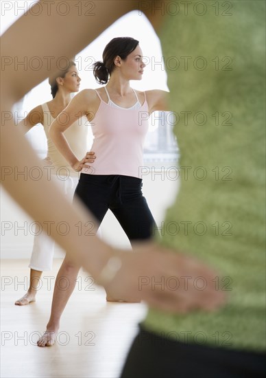 Three young women in yoga class