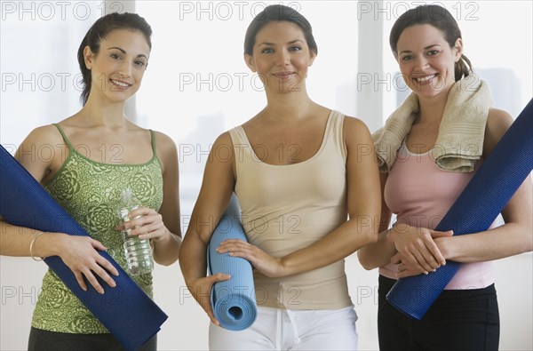 Three young women in yoga class
