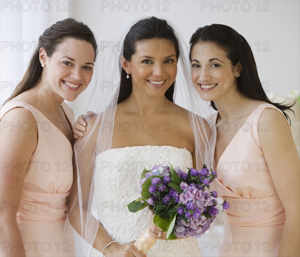 Portrait of Hispanic bride and bridesmaids