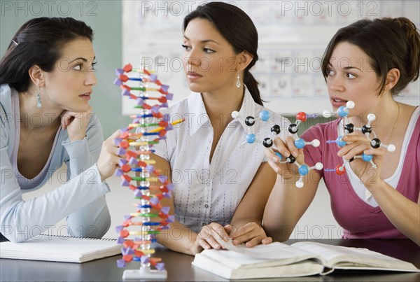 Three young women in science class