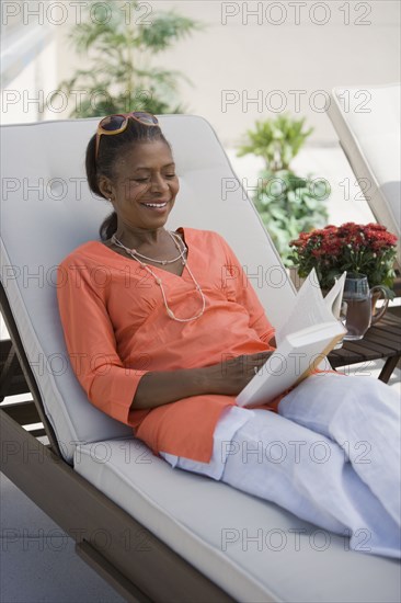 Senior African American woman reading book