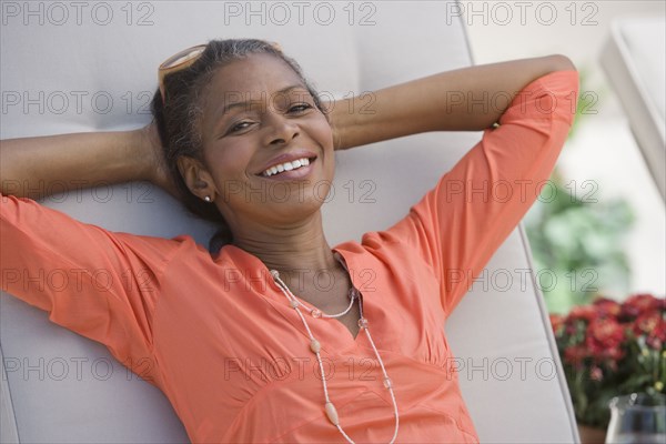 Senior African American woman with hands behind head