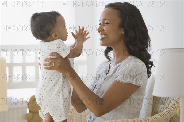 African American mother smiling at baby