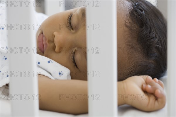 African American baby sleeping in crib