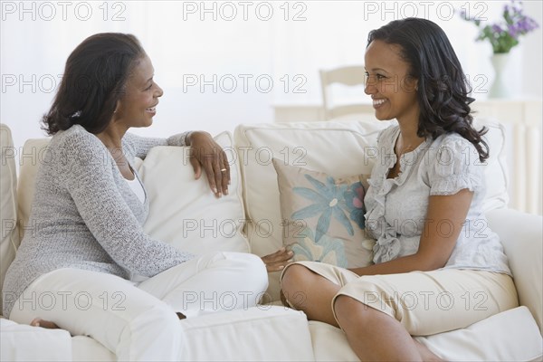 African American mother and adult daughter talking
