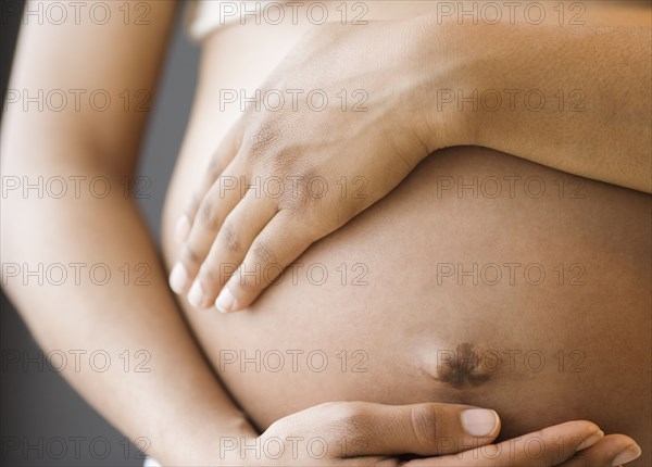 Close up of pregnant African American woman's belly