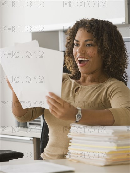 African businesswoman reading paperwork