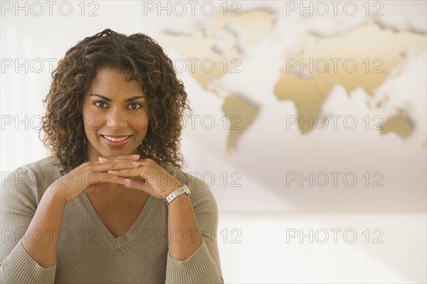 African businesswoman in front of world map