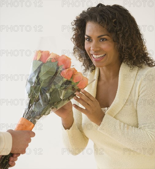 African woman receiving bouquet of flowers