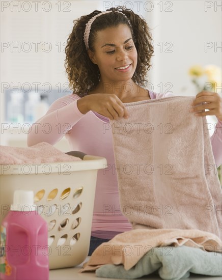 African woman folding laundry