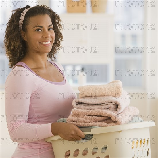 African woman carrying laundry basket