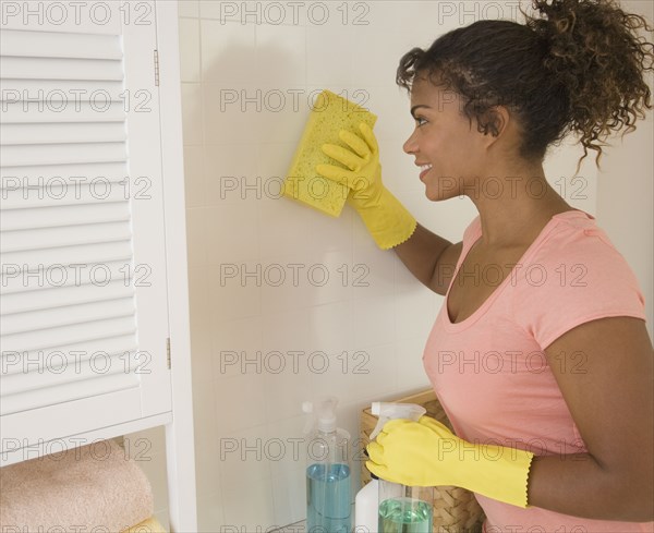 African woman washing wall