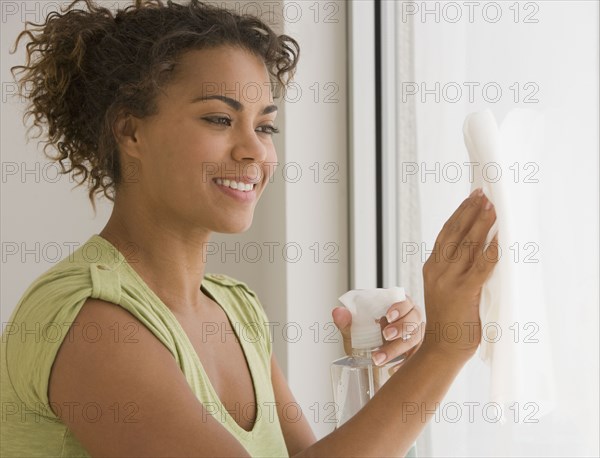African woman washing window