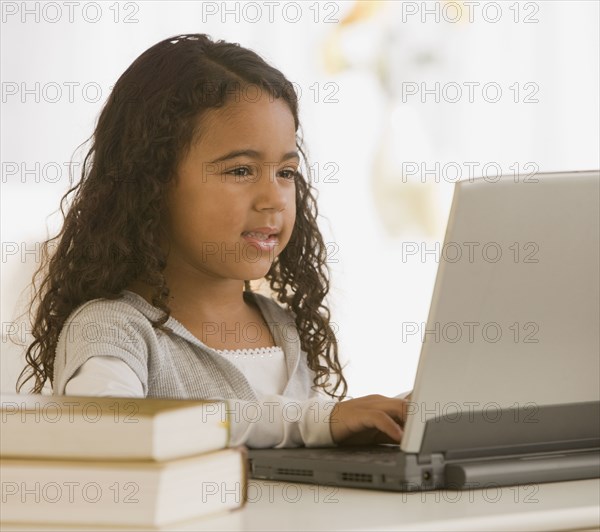 African girl typing on laptop