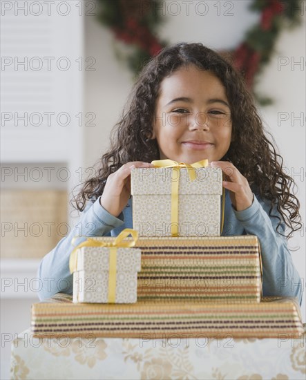 African girl behind stack of gifts