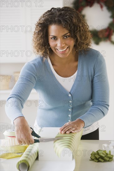 African woman wrapping gift
