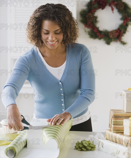 African woman wrapping gift